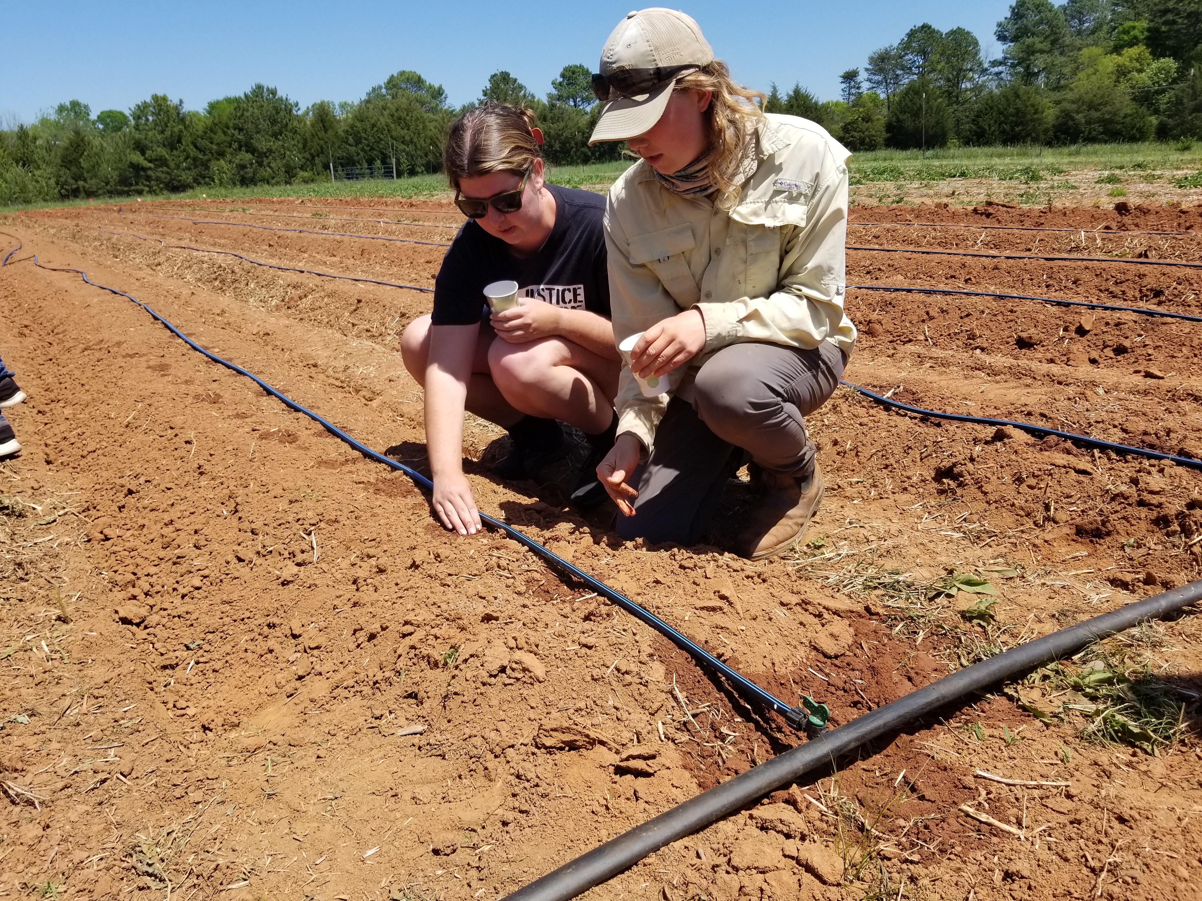 Halle Murphy and student planting Catawba corn