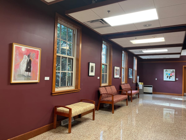 CUnningham Lobby, Maroon Hallway with colorful framed paintings