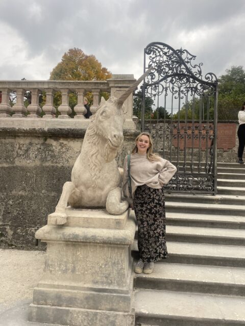 Image of Caroline Sillars beside a Unicorn statue