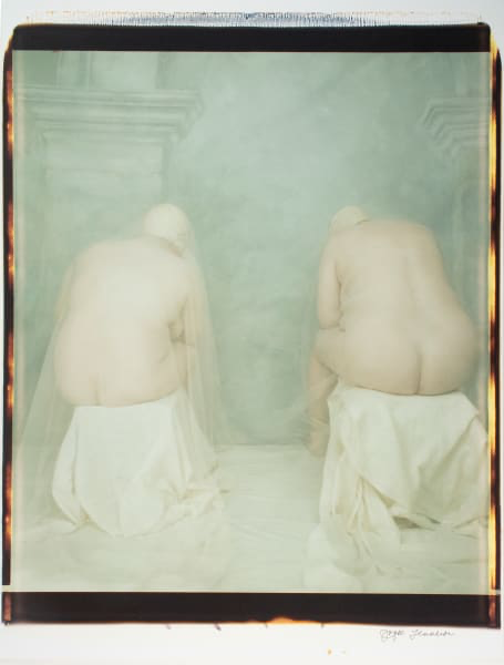 Two nude figures sit, exposing the back sides of their body.