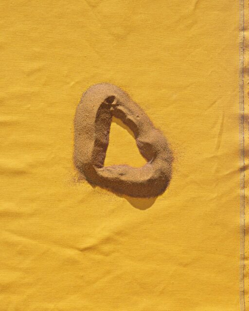 photography of a sand circle with yellow background by Malu Alvarez