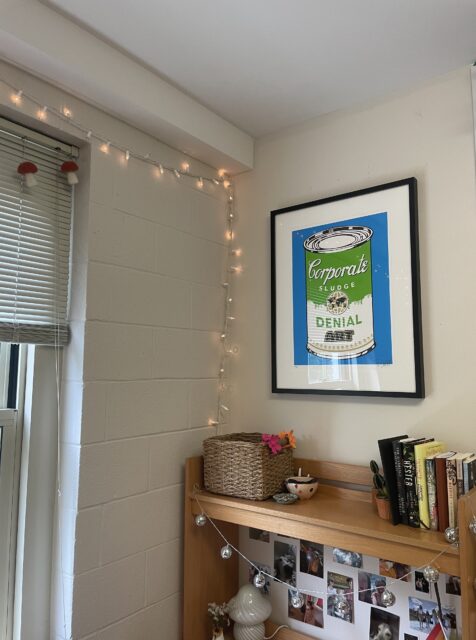 Image of Corporate Slude (Blue) Artwork in Sarah's room, hanging above a desk with books