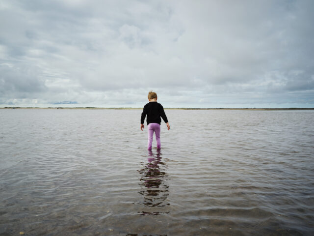 Image off child walking in ocean from Jess Dugan's video, 