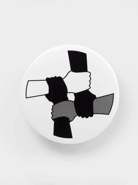 Image of four hands (two colored black, one white, and one patterned black and white) grabbing onto each others' wrists on a white circle background